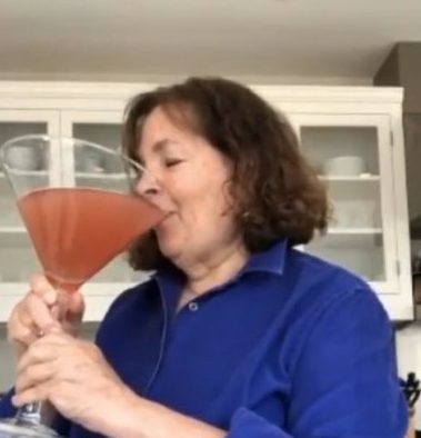 Ina Garten drinking from an enormous cocktail glass.